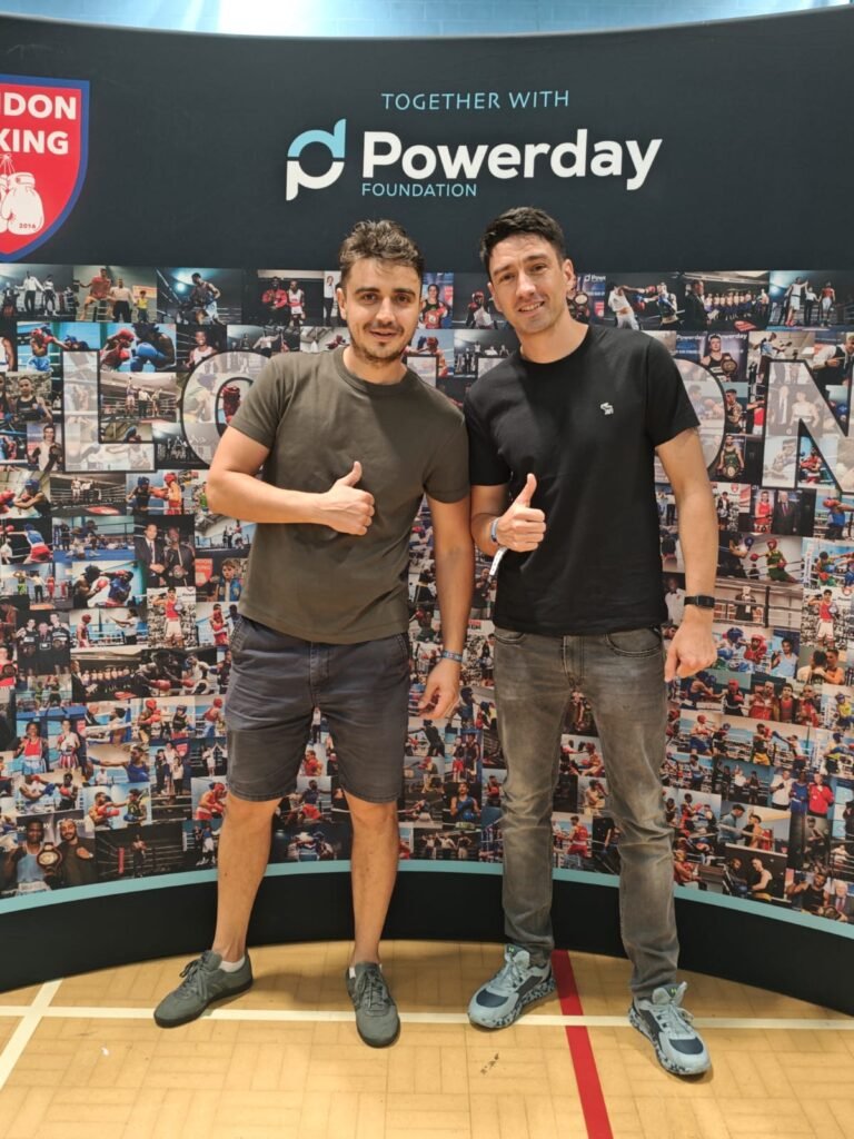 Certified boxing coach London | with a friend watching an amateur competition.