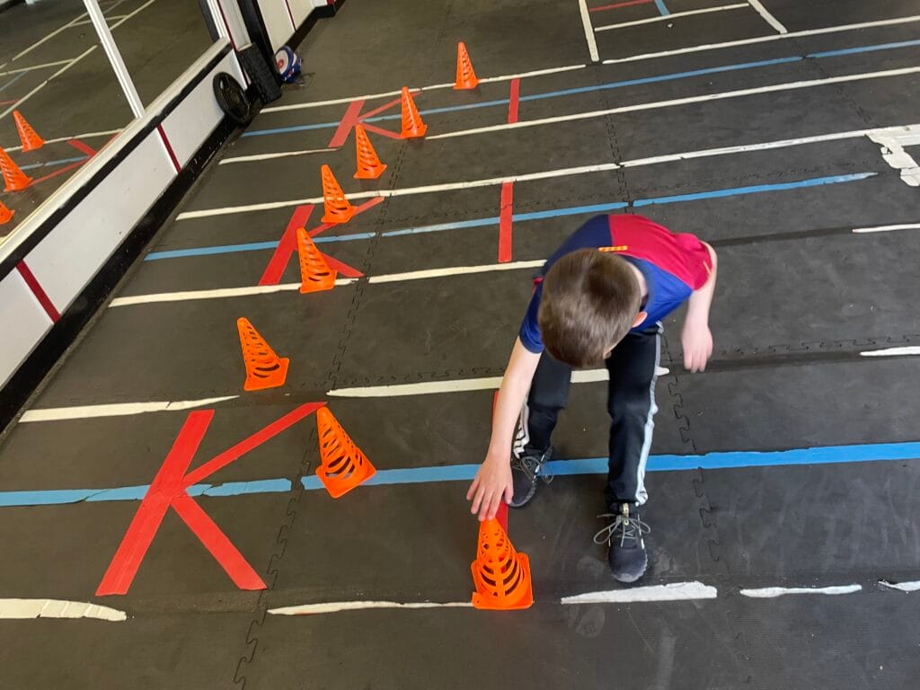 Kid working improving his skills. red and blue Barcelona t-shirt.